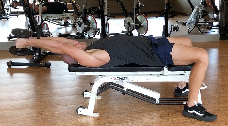 Joey Lamb, strength and conditioning coach and a personal trainer at Little Rock Athletic Club, demonstrates the Triceps Gravity Press at Little Rock Racquet Club for Matt Parrott's Master Class. (Arkansas Democrat-Gazette/Celia Storey)