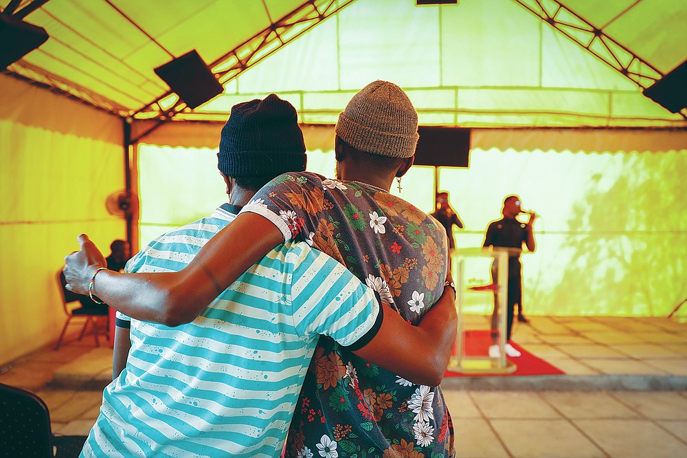 Worshippers embrace during a church service at the Cosmopolitan Affirming Community church, which serves a predominantly LGBTQ congregation, in Nairobi, Kenya, on Sunday, Oct. 17, 2021. In several African countries, bishops aligned with the worldwide United Methodist Church are preparing to join an in-the-works breakaway denomination so they can continue their practice of refusing to recognize same-sex marriage or ordain LGBTQ clergy. (AP Photo/Brian Inganga)