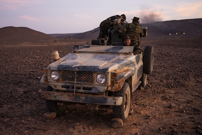 Polisario Front soldiers during a shooting exercise, near Mehaires, Western Sahara, Wednesday, Oct. 13, 2021. For nearly 30 years, the vast territory of Western Sahara in the North African desert has existed in limbo, awaiting a referendum that was supposed to let the local Sahrawi people decide their future. On one side, the Polisario Front wants the territory to be independent, while Morocco claims the area for itself. (AP Photo/Bernat Armangue)