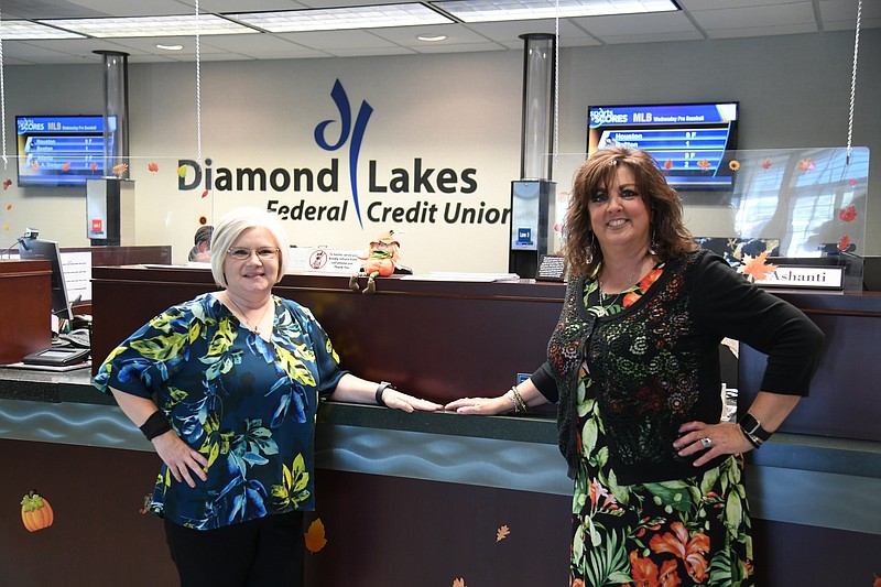 Nichole Meredith, branch manager, left, and Kim Kellar, marketing specialist, are shown in the lobby of Diamond Lakes Federal Credit Union. - Photo by Tanner Newton of The Sentinel-Record