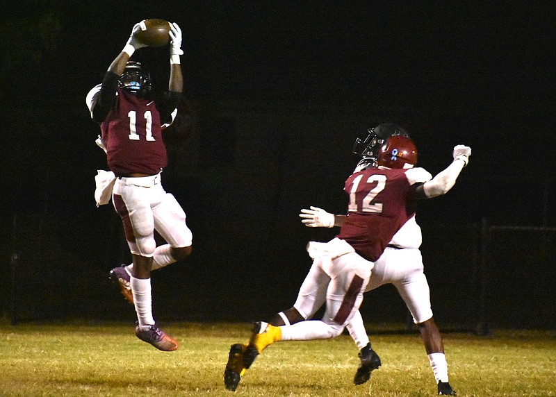 Dollarway defensive back Briveon Sample intercepts a pass deep in Smackover territory on Friday night at Cardinal Stadium. (Pine Bluff Commercial/I.C. Murrell)