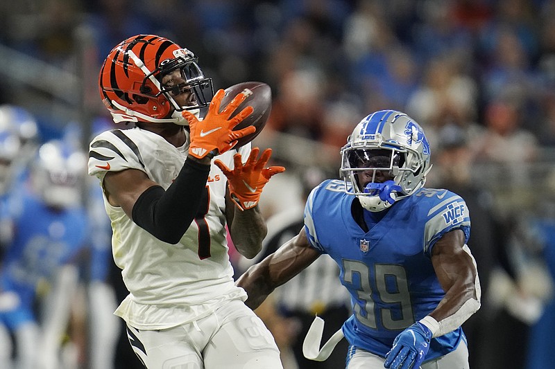 Cincinnati Bengals wide receiver Ja'Marr Chase (1) catches as Detroit Lions cornerback Jerry Jacobs (39) defends during the first half of an NFL football game, Sunday, Oct. 17, 2021, in Detroit. (AP Photo/Paul Sancya)