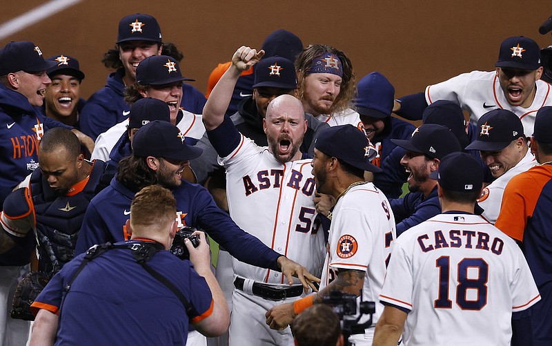 Houston Astros relief pitcher Ryan Pressly and teammates celebrate after a 5-0 win over the Boston Red Sox in Game 6 of the baseball AL Championship Series, Friday, Oct. 22, 2021, in Houston. The Astros advanced to the World Series (Kevin M. Cox/The Galveston County Daily News via AP)