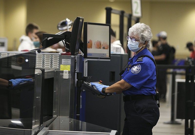 Laura Brinza, transportation security officer, scans luggage, Friday, October 22, 2021 at the Bentonville National Airport in Bentonville. Incidents of people bringing guns to airport security checkpoints are up across the country and Northwest Arkansas National Airport has had 24 such incidents so far this year, according to airport officials. Check out nwaonline.com/211023Daily/ for today's photo gallery. 
(NWA Democrat-Gazette/Charlie Kaijo)