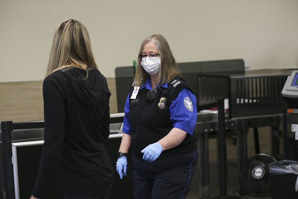 Robin Young, transportation security officer supervisor, waves an attendee through security, Friday, October 22, 2021 at the Bentonville National Airport in Bentonville. Incidents of people bringing guns to airport security checkpoints are up across the country and Northwest Arkansas National Airport has had 24 such incidents so far this year, according to airport officials. Check out nwaonline.com/211023Daily/ for today's photo gallery.
(NWA Democrat-Gazette/Charlie Kaijo)