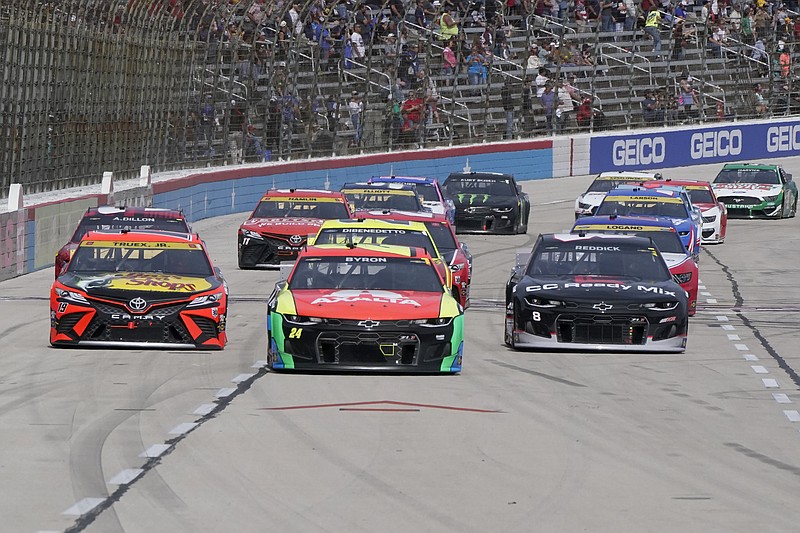 Drivers, from left to right, Martin Truex Jr. (19), William Byron (24) and Tyler Reddick (8) make their way around the track during a NASCAR Cup Series auto race at Texas Motor Speedway Sunday, Oct. 17, 2021, in Fort Worth, Texas. (AP Photo/Larry Papke)
