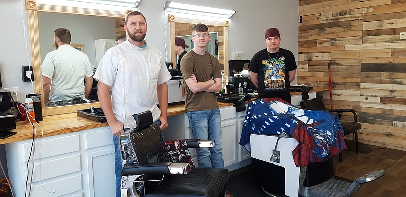 Stephen Brown, left, owner of Hairy Armadillo and his new additional barbers, Garret McNeil, middle, and Rooster Johnson, right. (Staff photo by Junius Stone)