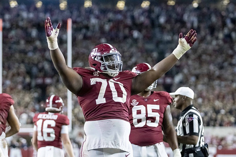Alabama offensive lineman Javion Cohen (70) signals a touchdown after a dive into the end zone by quarterback Bryce Young during the second half of an NCAA college football game against Tennessee, Saturday, Oct. 23, 2021, in Tuscaloosa, Ala. (AP Photo/Vasha Hunt)