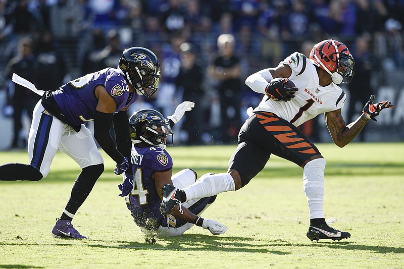 Baltimore Ravens safety Chuck Clark (36) and cornerback Marlon Humphrey (44) miss a tackle of Cincinnati Bengals wide receiver Ja'Marr Chase (1) before he took off for a long touchdown on a reception during the second half of an NFL football game, Sunday, Oct. 24, 2021, in Baltimore. (AP Photo/Gail Burton)