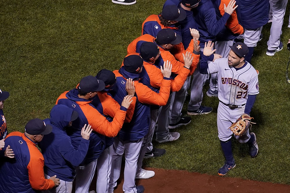 Houston Astros second baseman Jose Altuve celebrates with teammates after their win against the Boston Red Sox in Game 4 of baseball's American League Championship Series Wednesday, Oct. 20, 2021, in Boston. (AP Photo/Charles Krupa)