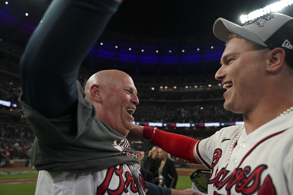 Atlanta Braves manager Brian Snitker celebrates with Joc Pederson after winning Game 6 of baseball's National League Championship Series against the Los Angeles Dodgers Sunday, Oct. 24, 2021, in Atlanta. The Braves defeated the Dodgers 4-2 to win the series. (AP Photo/Brynn Anderson)