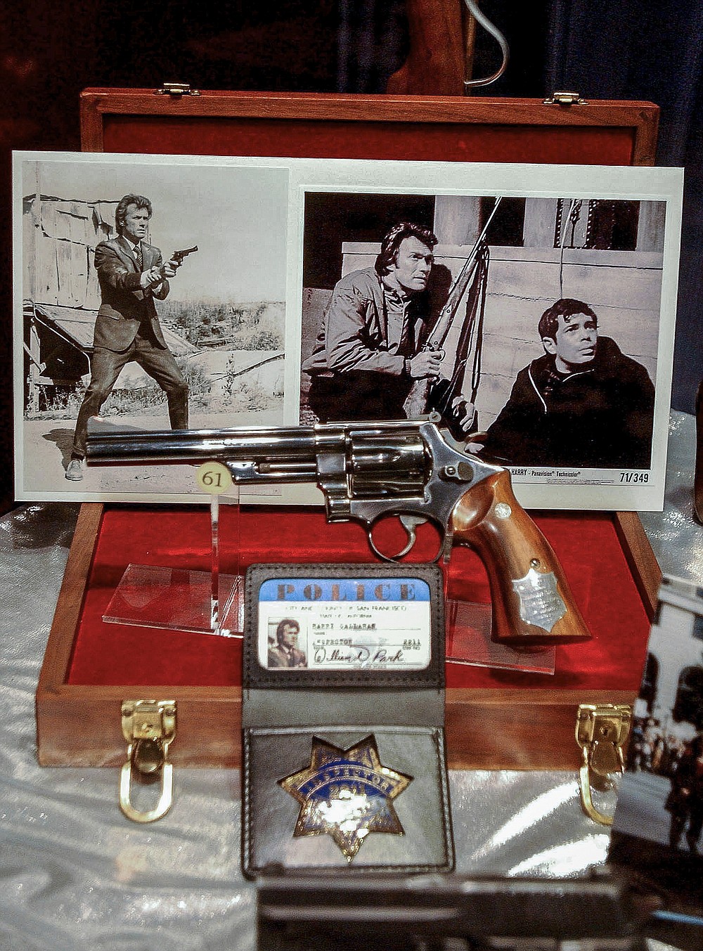 FILE - In this Wednesday, April 17, 2002, file photo, items from the National Firearms Museum exhibit of guns and memorabilia used in movies, such as Clint Eastwood's gun and badge from "Dirty Harry," are shown at the NRA Headquarters in Fairfax, Va. Guns used in making movies are sometimes real weapons that can fire either bullets or blanks, which are gunpowder charges that produce a flash and a bang but no deadly projectile. Even blanks can eject hot gases and paper or plastic wadding from the barrel that can be lethal at close range. (AP Photo/Linda Spillers, File)