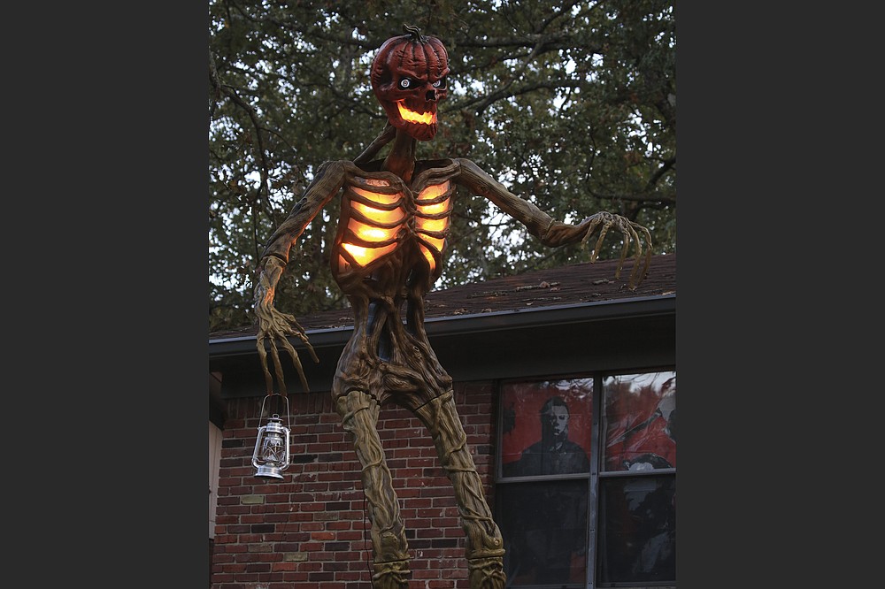 This year, the Inferno, a 12-foot skeleton decoration with menacing pumpkin head, was highly sought after but rarely found by Halloween decorators. Hitchcock managed to get one after someone in a Halloween enthusiasts Facebook group mentioned there was an Inferno available in Fort Smith. She made a call, made the trip and scored her prize. (Arkansas Democrat-Gazette/Staton Breidenthal)