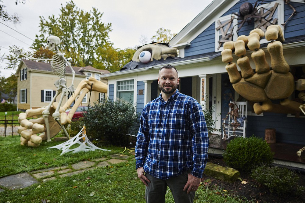 Alan Perkins poses with the Halloween display he has created in front of his home on Oct. 22 in Olmsted Falls, Ohio. (The Washington Post/Angelo Merendino)