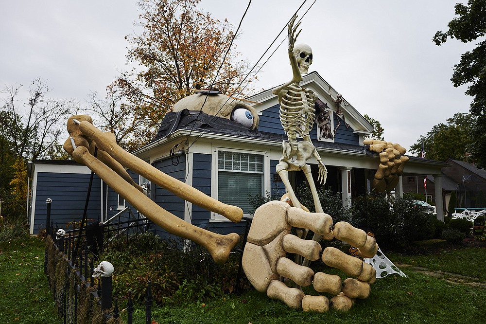 Skeletons and other Halloween decorations fill the yard in front of Alan Perkins’ home. (The Washington Post/Angelo Merendino)