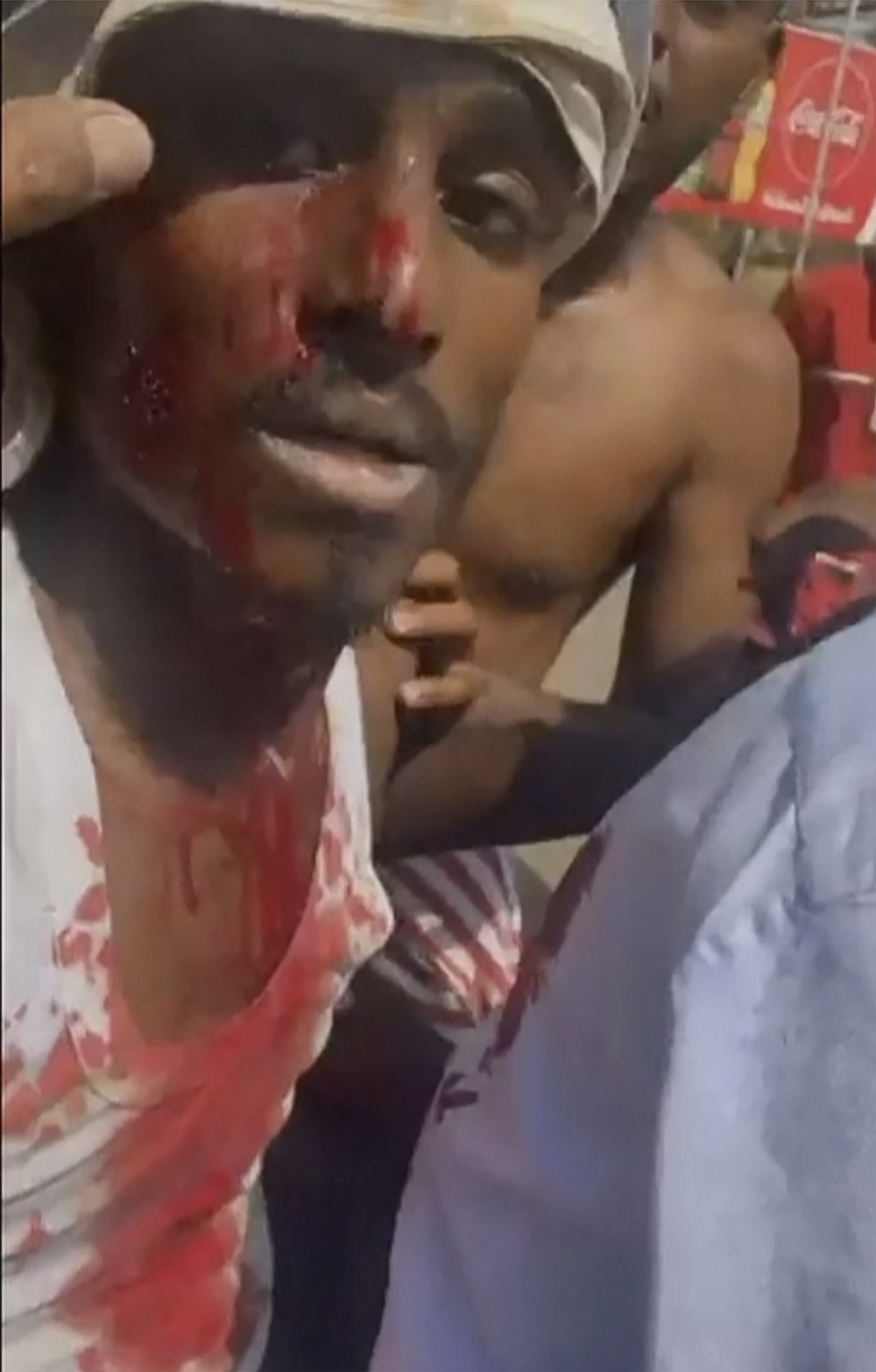 In this frame taken from video a wounded protester is taken away on a motorcycle during a protest in Khartoum, Sudan, Monday, Oct. 25, 2021. Sudan’s leading general has dissolved the government and says the military will run the country until elections in 2023. His announcement came hours after his forces arrested the acting prime minister and other senior government officials. In a televised address Monday, Gen. Abdel-Fattah Burhan declared a state of emergency and dissolved the country's ruling Sovereign Council as well as the government. (AP Photo)