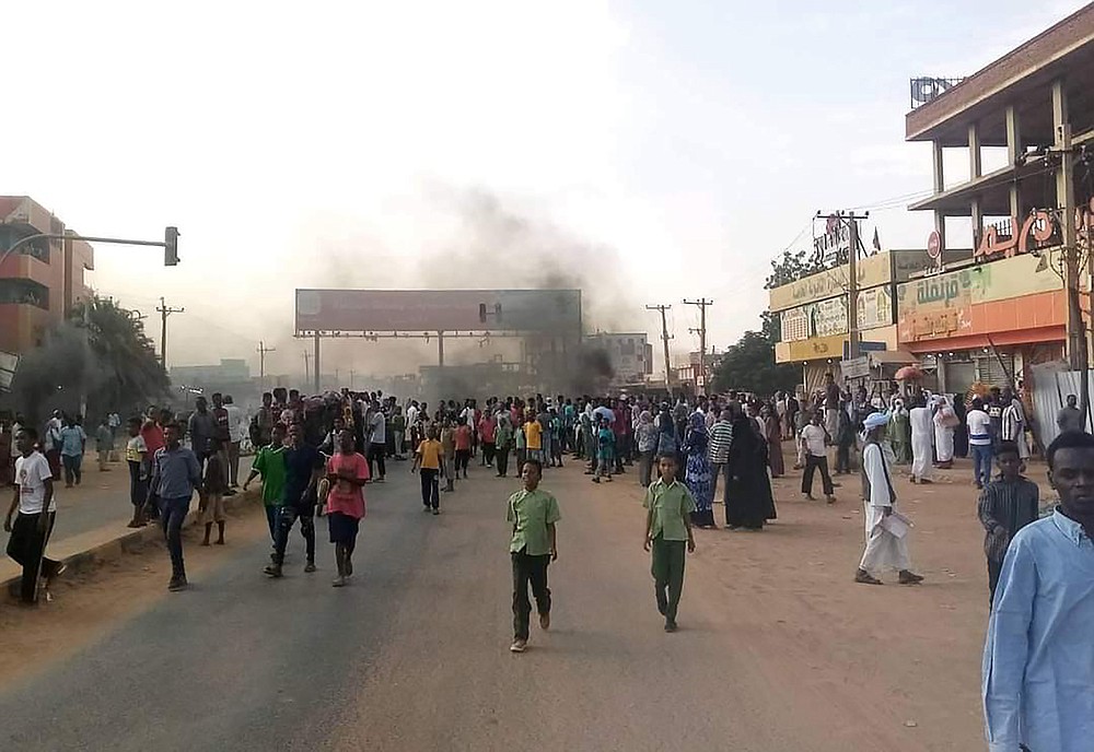 Pro-democracy protesters take to the streets to condemn a takeover by military officials in Khartoum, Sudan, Monday Oct. 25, 2021. Sudan’s military seized power Monday, dissolving the transitional government hours after troops arrested the acting prime minister and other officials. The takeover comes more than two years after protesters forced the ouster of longtime autocrat Omar al-Bashir and just weeks before the military was expected to hand the leadership of the council that runs the African country over to civilians. (AP Photo/Ashraf Idris)