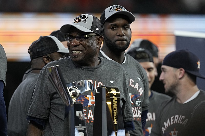 Houston Astros manager Dusty Baker Jr. stands by the trophy after their win against the Boston Red Sox in Game 6 of baseball's American League Championship Series Friday, Oct. 22, 2021, in Houston. The Astros won 5-0, to win the ALCS series in game six.(AP Photo/Tony Gutierrez)