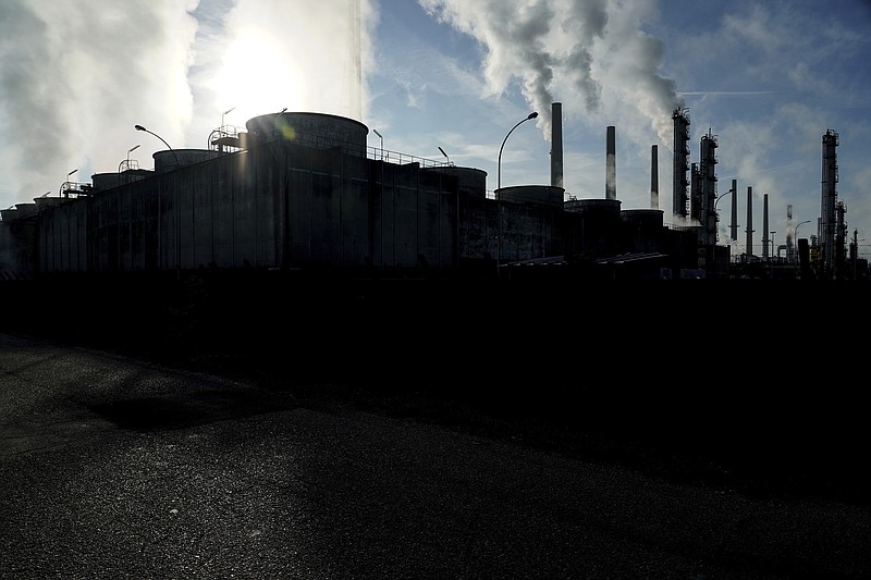 FILE - In this Oct. 15, 2021 file photo, smoke rises from the Feyzin Total refinery chimneys, outside Lyon, central France. The World Meteorological Organization says greenhouse gas concentrations hit a new record high last year and continued to increase at a faster clip than the average rate in the last decade, despite a temporary blip downward amid coronavirus-linked lockdowns.  The U.N. weather agency, releasing its flagship annual report on heat-trapping gases in the atmosphere on Monday Oct. 25, 2021, said concentrations of carbon dioxide, methane and nitrous oxide are all above levels in the pre-industrial era pegged to before 1750, when human activities &#x201c;started disrupting Earth&#x2019;s natural equilibrium.&#x201d;(AP Photo/Laurent Cipriani, file)