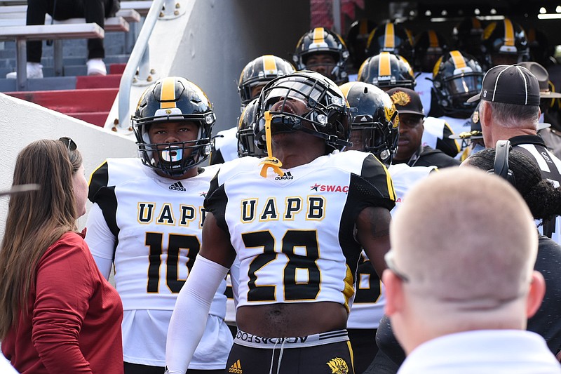 UAPB cornerback Solomon Brooks (28) leads the charge onto the field before kickoff against Arkansas on Saturday, Oct. 23, 2021, at War Memorial Stadium in Little Rock. (Pine Bluff Commercial/I.C. Murrell)