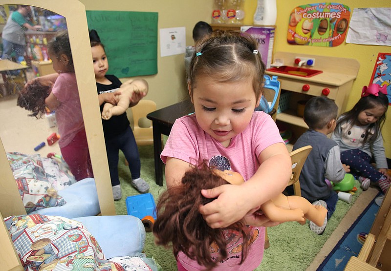 NWA Democrat-Gazette/DAVID GOTTSCHALK Abbygail Gonzalez, 3, plays with her doll Monday, March 12, 2018, in the Arkansas Better Chance Toddler Room at the Northwest Arkansas Sunshine School and Development Center in Little Flock. The school has been serving the area for more than 50 years.