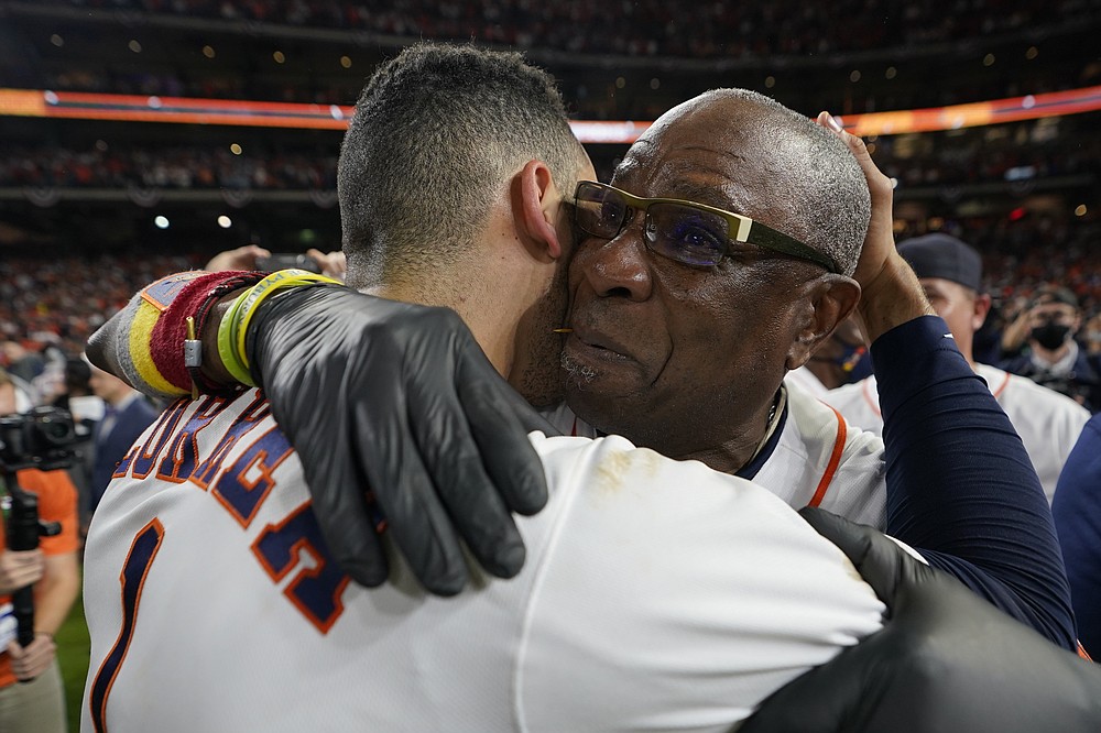 Houston Astros manager Dusty Baker Jr. and shortstop Carlos Correa celebrate their win against the Boston Red Sox in Game 6 of baseball's American League Championship Series Friday, Oct. 22, 2021, in Houston. The Astros won 5-0, to win the ALCS series in game six. (AP Photo/David J. Phillip)