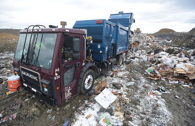 A garbage truck driven by Gustavo Garcia unloads waste at the Fort Smith landfill in this Friday, Oct. 29, 2021 file photo. Go to nwaonline.com/211030Daily/ to see more photos. (NWA Democrat-Gazette/Hank Layton)