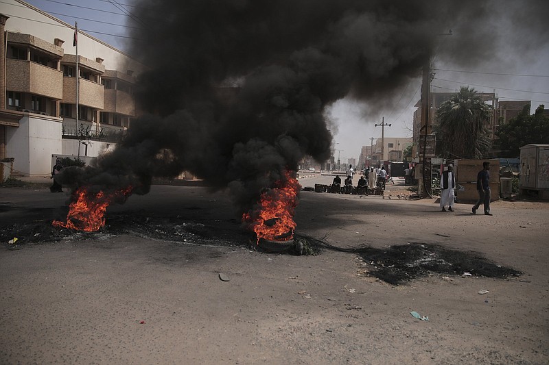 People burn tires during a protest a day after the military seized power Khartoum, Sudan, Tuesday, Oct. 26, 2021. The takeover came after weeks of mounting tensions between military and civilian leaders over the course and the pace of Sudan's transition to democracy. (AP Photo/Marwan Ali)