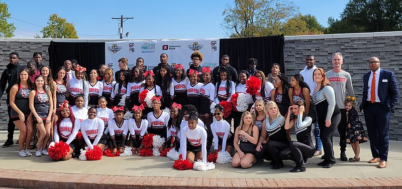 Cheerleaders, basketball coaches and players and organizers of the King Cotton Holiday Classic gather for a group photo following a news conference at the Sixth Avenue Plaza on Tuesday, Oct. 26, 2021. (Pine Bluff Commercial/I.C. Murrell)