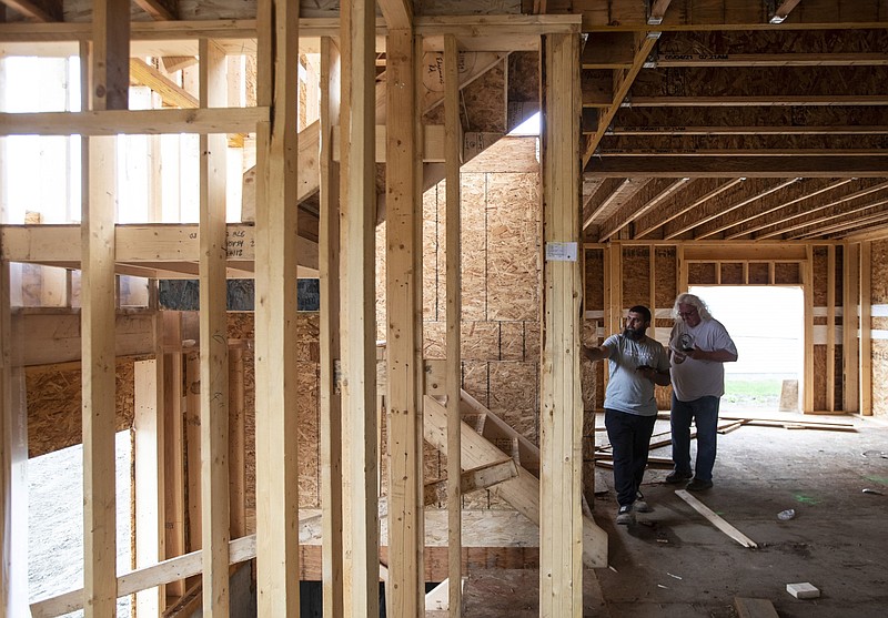 Workers inspect a home under construction by Akash Homes in Edmonton, Alberta, on June 15, 2021. MUST CREDIT: Bloomberg photo by Jason Franson.