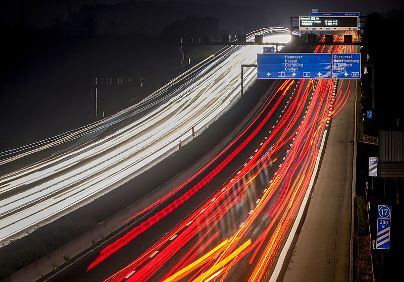 In this long time exposure photo, trucks and cars roll on a highway in Frankfurt, Germany, Tuesday, Oct. 26, 2021. (AP Photo/Michael Probst)