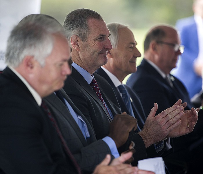 Trex CEO Bryan Fairbanks sits among local officials including Mayor Frank Scott, Jr. and Governor Hutchinson during an announcement of a new factory that will be built in the Port of Little Rock on Tuesday, Oct. 26, 2021. The new factory will bring 500 jobs and an estimated $400 million over the next five years in the development of the new Arkansas site, according to a press release. See more photos at arkansasonline.com/1027port/

(Arkansas Democrat-Gazette/Stephen Swofford)