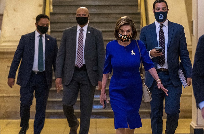House Speaker Nancy Pelosi of Calif., arrives for a meeting with House Democrats on Capitol Hill in Washington, Tuesday, Oct. 26, 2021. (AP Photo/Andrew Harnik)