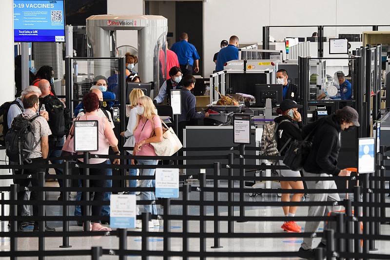 Travelers enter a new Transportation Security Administration screening area during the opening of the Terminal 1 expansion at Los Angeles International Airport on June 4, 2021 in Los Angeles. (Patrick T. Fallon/AFP/Getty Images/TNS)