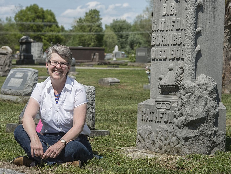NWA Democrat-Gazette/ANTHONY REYES &#x2022; @NWATONYR
Abby Burnett, author, Tuesday, April 21, 2015 next to one of the tombstones at Bluff Cemetery that piqued her interest in Springdale.