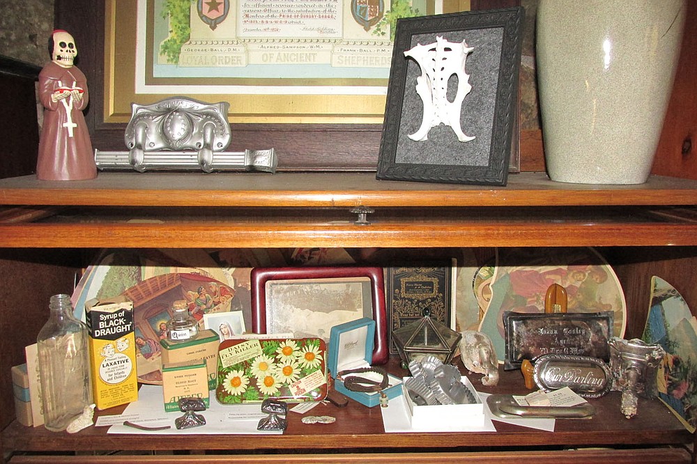 Burnett keeps much of her collection of death paraphernalia in a glass-fronted bookcase that she calls the Cabinet of Morbid Curiosities.  (Courtesy photo / Abby Burnett)