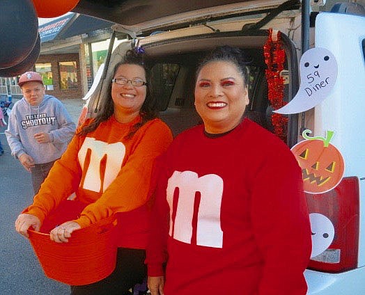 Westside Eagle Observer/SUSAN HOLLAND
Carol Thompson, owner of 59 Diner, and her daughter-in-law Whitley Holland wear big smiles as they hand out candy at Trick or Treat on Main Street. The ladies were chuckling over the expression on the face of the young man at left who had just eaten a piece of sour candy they had given him.
