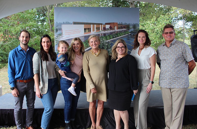 (from left), , ,  Jane Hunt; Elizabeth Shackelford; Emily Rappe Fisher and Bryan Hunt gather in front of a rendering of the planned J.B. and Johnelle Hunt Family Children&#x2019;s Safety Center of Washington County on Oct. 12 at a celebration to mark the Hunt family's $3 million gift to the safety center's Healing the Future capital campaign to build a new facility in Springdale.
(NWA Democrat-Gazette/Carin Schoppmeyer)