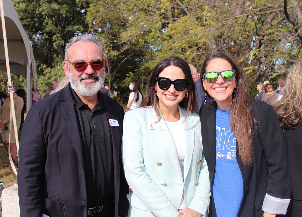 Children's Safety Center board members Andy Murray (left to right), Sarah White and Casey Atwood take a photo during the October 12 announcement. (NWA Democrat-Gazette / Carin Schoppmeyer)