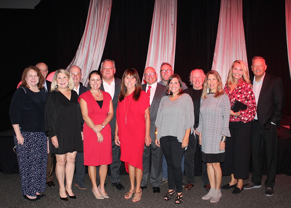 Lisa and Howard Higgins (left to right), Carren and Scott Audrain, Mary and Coleman Ward, Leslie and Ted Beldon, Randy and Melissa Werner, Greg House and Beverly Block and Debbie and Dwight Power enjoy the awards ceremony of the Arkansas Alumni Association. The Beldens received the association's Andrew J. Lucas Alumni Service Award. (NWA Democrat-Gazette / Carin Schoppmeyer)
