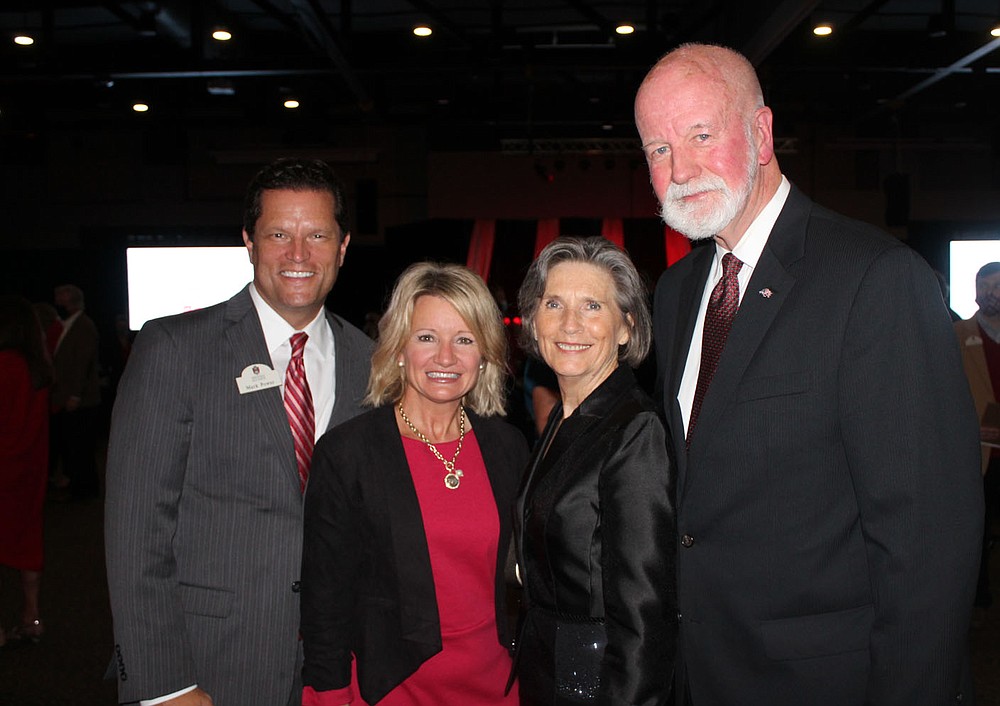 AU Vice-Chancellor for Advancement Mark Power and his wife Corrine (left to right) visit Terry and Mike Johnson, recipient of the Alumni Honorary Award, on October 14. (NWA Democrat-Gazette / Carin Schoppmeyer)