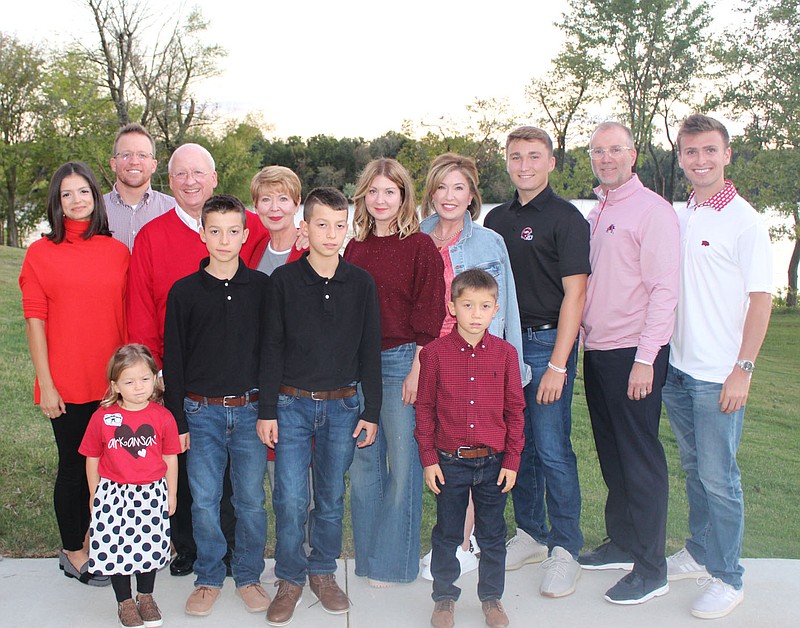 Gary and Robin George (back, third and fourth from left) are joined by children and grandchildren Oct. 15 at the Brandon Burlsworth Foundation Legends dinner at Heroncrest in Springdale. 
(NWA Democrat-Gazette/Carin Schoppmeyer)