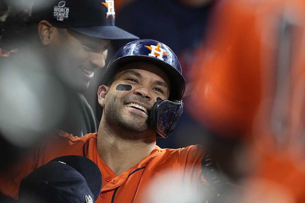 Houston Astros' Jose Altuve celebrates in the dugout after a home run during the seventh inning in Game 2 of baseball's World Series between the Houston Astros and the Atlanta Braves Wednesday, Oct. 27, 2021, in Houston. (AP Photo/David J. Phillip)