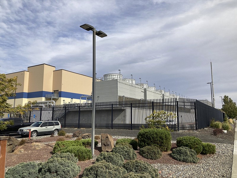 In this Tuesday, Oct. 5, 2021, photo, shows the exterior of a Google data center in The Dalles, Oregon. The Dalles City Council member Long-Curtiss wants to know more details about Google's proposal to build more data centers in the town before the city council votes on the matter. As demand for cloud computing grows, the world's biggest tech companies are building more data centers, including in arid regions even though they use vast amounts of water per day. Some residents of The Dalles, Oregon, are objecting to a proposal by Google to build more data centers there, fearing that, amid rising temperatures and drought, there won't be enough water for everyone. (AP Photo/Andrew Selsky)