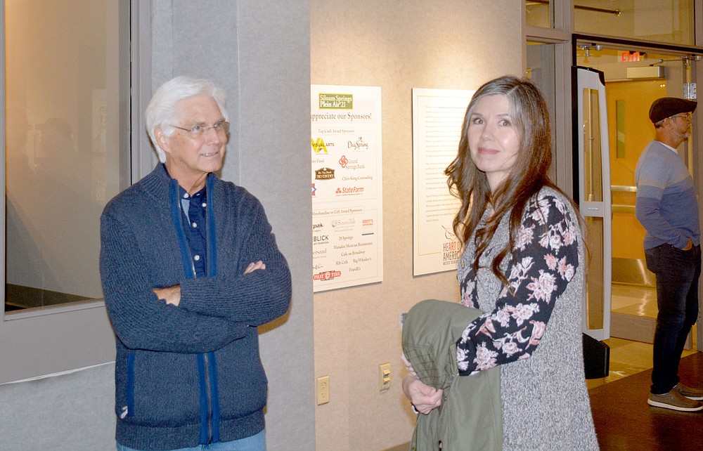 Marc Hayot / Siloam Sunday Artists Charles Peer (left) and Cheryl Elliott discuss their work and the outdoor event held Thursday at the Wingate Gallery at John Brown University.