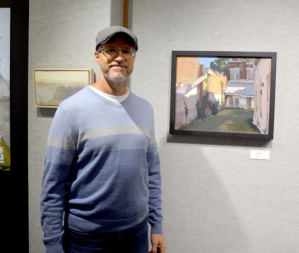Marc Hayot / Siloam Sunday John Laster, artist and director of marketing and design at Heart of American Artists Association poses in front of his oil painting 