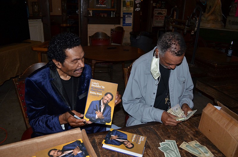 Blues legend Bobby Rush conducts a signing of his autobiography, 'Ain't Studdin' Ya/My American Blues Story.' The Grammy award winner sold and signed 40 copies in 15 minutes recently. (Special to The Commercial/Richard Ledbetter)