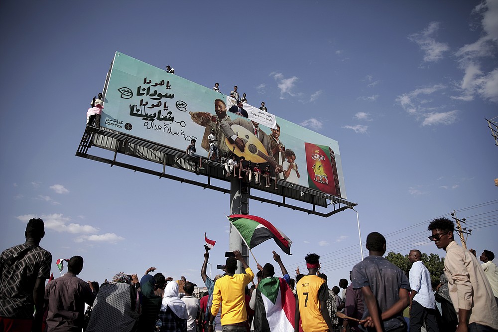 People chant slogans during a protest in Khartoum, Sudan, Saturday, Oct. 30, 2021. Pro-democracy groups called for mass protest marches across the country Saturday to press demands for re-instating a deposed transitional government and releasing senior political figures from detention. (AP Photo/Marwan Ali)