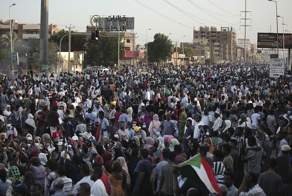 People chant slogans during a protest in Khartoum, Sudan, Saturday, Oct. 30, 2021. Pro-democracy groups called for mass protest marches across the country Saturday to press demands for re-instating a deposed transitional government and releasing senior political figures from detention. (AP Photo/Marwan Ali)