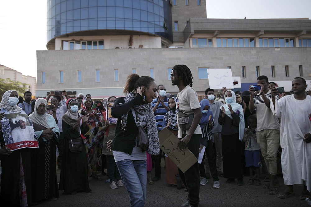 People chant slogans during a protest in Khartoum, Sudan, Saturday, Oct. 30, 2021. Pro-democracy groups called for mass protest marches across the country Saturday to press demands for re-instating a deposed transitional government and releasing senior political figures from detention. (AP Photo/Marwan Ali)
